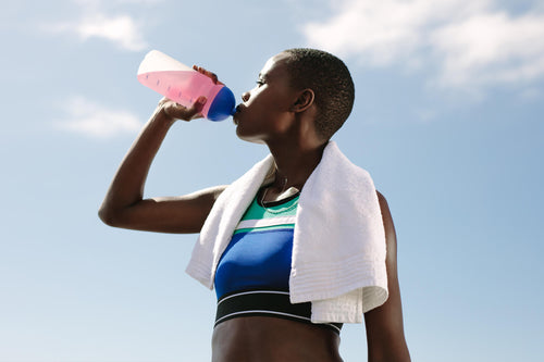 woman hydrating with a sports drink